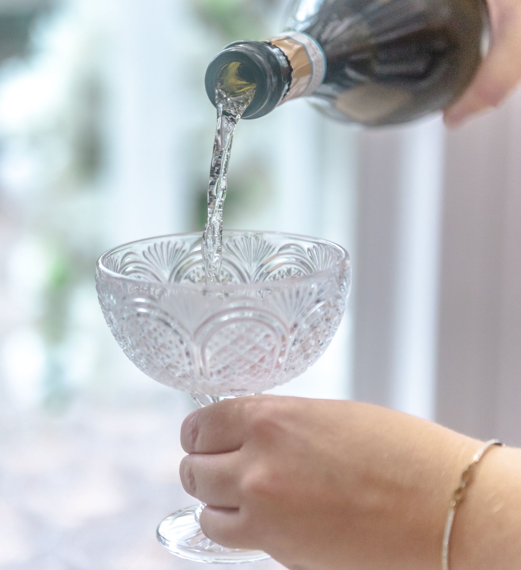 Woman Pouring Champagne into a Glass Closeup-min.jpg